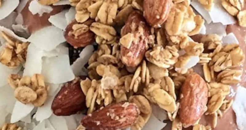 chaga cacao smoothie bowl with nuts and coconut shavings on top