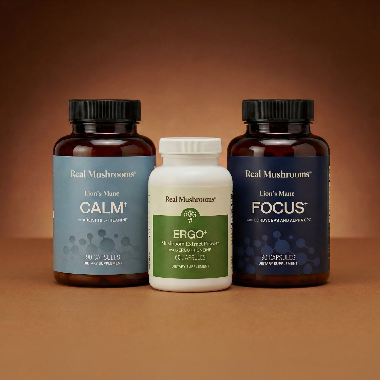 The Real Mushrooms Cognitive, Stress & Longevity Support Bundle is displayed against a brown gradient background, highlighting premium mushroom extracts designed to aid relaxation and cognitive performance.
