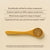 A wooden spoon with brown mushroom powder sits on a beige surface beside text highlighting Daily Dawg Powder for Pets by Real Mushrooms, an organic dog supplement that supports immune, gut, and nervous system health.