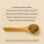 A wooden spoon with mushroom powder rests on a beige surface beside text showcasing the health benefits of Real Mushrooms’ Pet Defenders with Qrill™Pet, an organic supplement for immune support in pets.