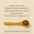 A wooden spoon holding Real Mushrooms’ RealRest—Reishi, Valerian, and Lemon Balm powder—rests on a beige surface, with nearby text highlighting product benefits and a disclaimer.