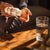Someone pours Real Mushrooms Organic Cordyceps Extract Capsules from the bottle into their hand, with a glass of water on a wooden table nearby, ready to support natural energy.