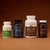 Four bottles of Real Mushrooms supplements—ERGO+, FOCUS, LION’S MANE, and RealMycelium—are arranged side by side against a brown background. The Brain Boosting Bundle from Real Mushrooms is expertly formulated to support cognitive function and brain health.