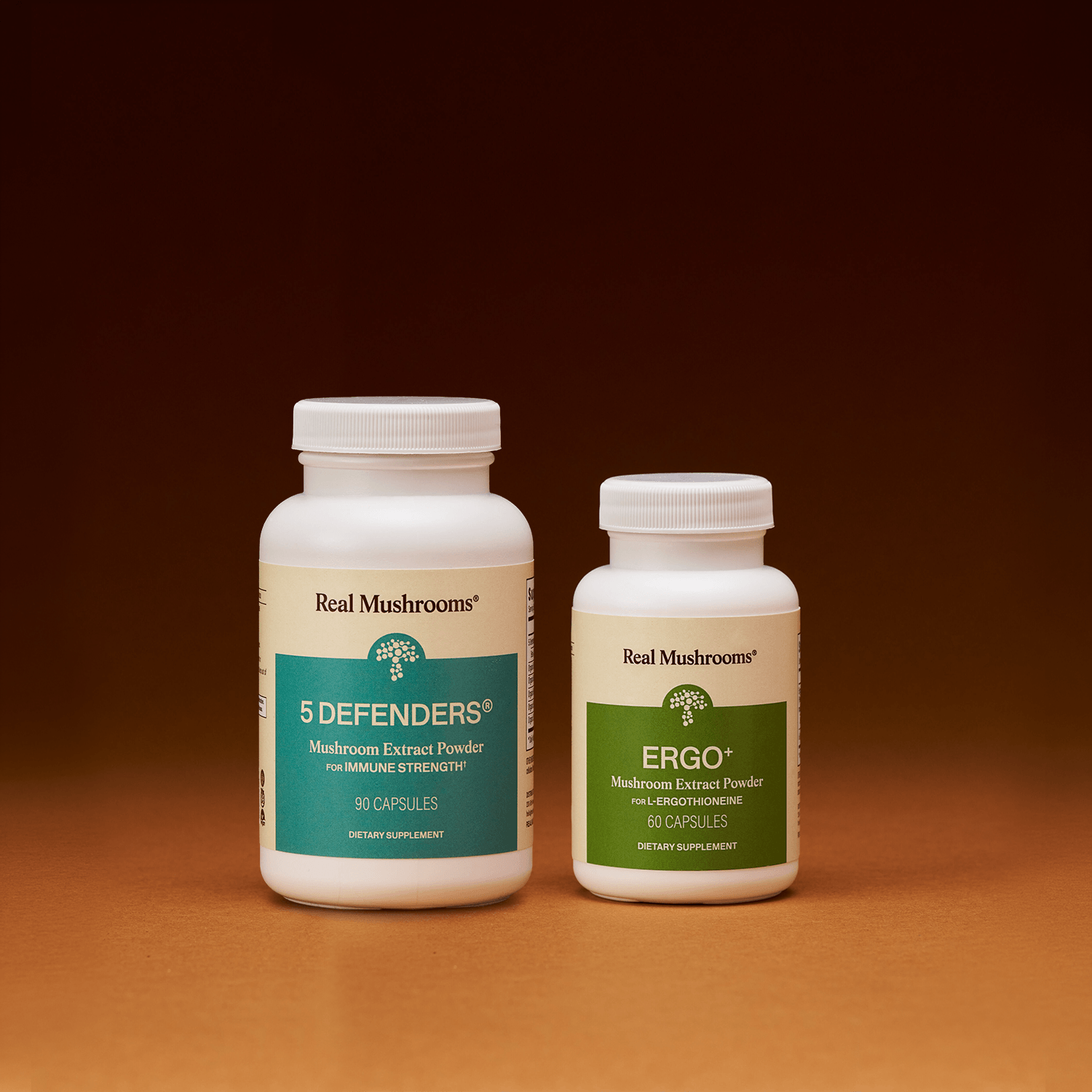 Two white bottles of Real Mushrooms Immune Power supplements are displayed side by side against a brown gradient background, highlighting premium mushroom formulas for immune support.