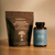 A Calm Ritual Duo from Real Mushrooms, featuring Mushroom Hot Chocolate Mix and Lion’s Mane CALM capsules, rests on a beige surface.