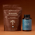 The Real Mushrooms Calm Ritual Duo, featuring Mushroom Hot Chocolate Mix and Lion’s Mane CALM capsules, is displayed together against a brown background—ideal for enjoying calm clarity.