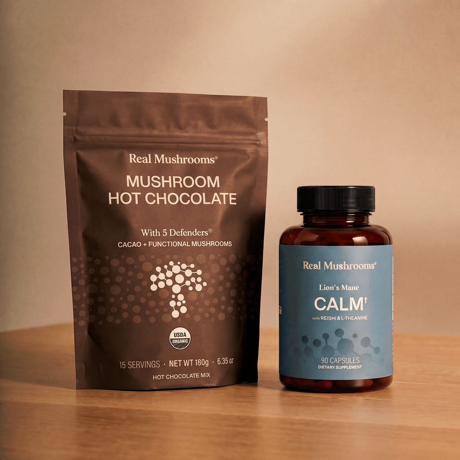 The Calm Ritual Duo from Real Mushrooms rests on a wooden surface against a neutral background.