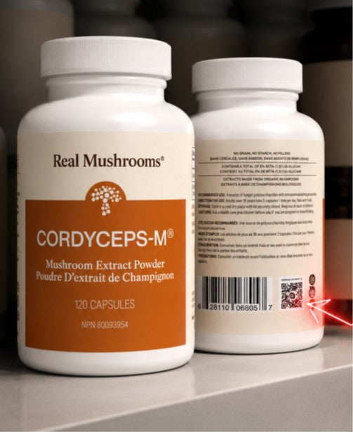Two white bottles of “Real Mushrooms Cordyceps-M” mushroom extract capsules are displayed, one showing the front label and the other the back label with a barcode and QR code.