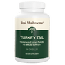 A white bottle labeled "Real Mushrooms Turkey Tail Mushroom Capsules," containing 90 capsules rich in beta-glucans for immune support.