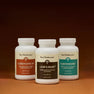 Three bottles of Real Mushrooms’ The Big 3 supplements are arranged side by side on a plain surface with a neutral background, highlighting their mushroom extracts for brain health and immune support.