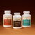 Real Mushrooms’ The Big 3 supplements are shown side by side on a brown surface with a gradient background, highlighting their mushroom extracts that support brain health and immune function.