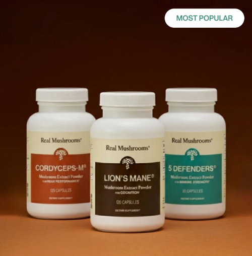 Three bottles of Real Mushrooms supplements—Cordyceps-M, Lion’s Mane, and 5 Defenders—are displayed against a brown background.