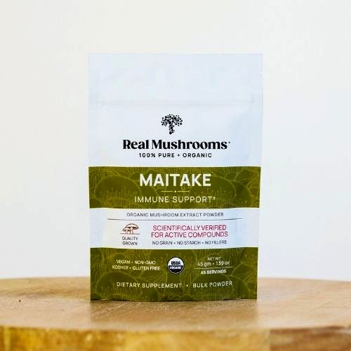 bag of maitake supplement powder on a wood table