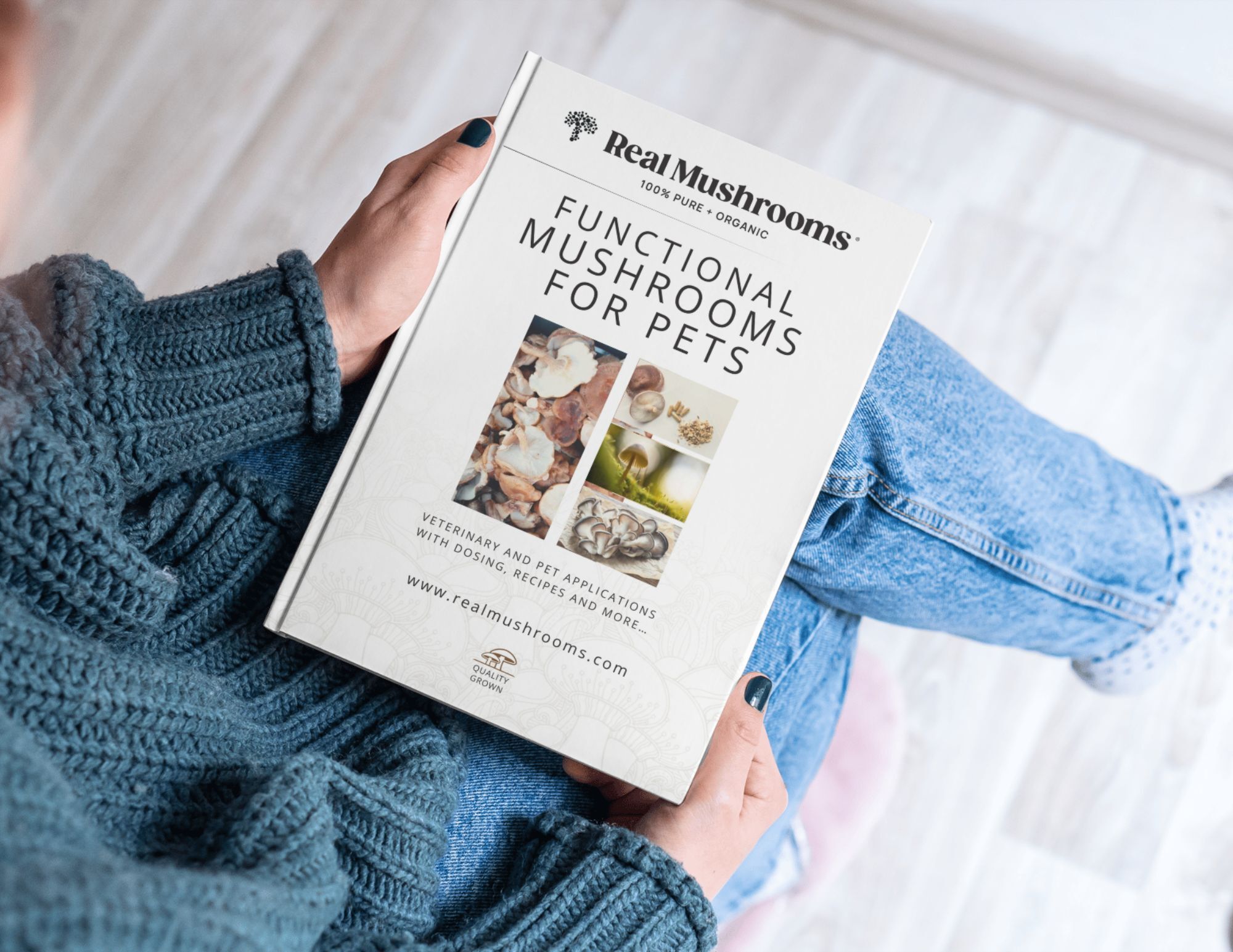 Person holding a book titled "Functional Mushrooms for Pets," featuring images of various mushrooms on the cover.