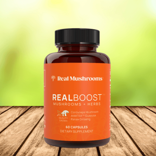 realboost mushroom and herbs supplement bottle on wood planks