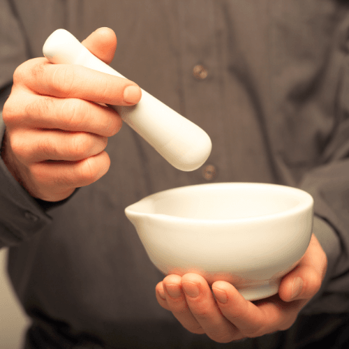 hands holding a mortar and a pestle